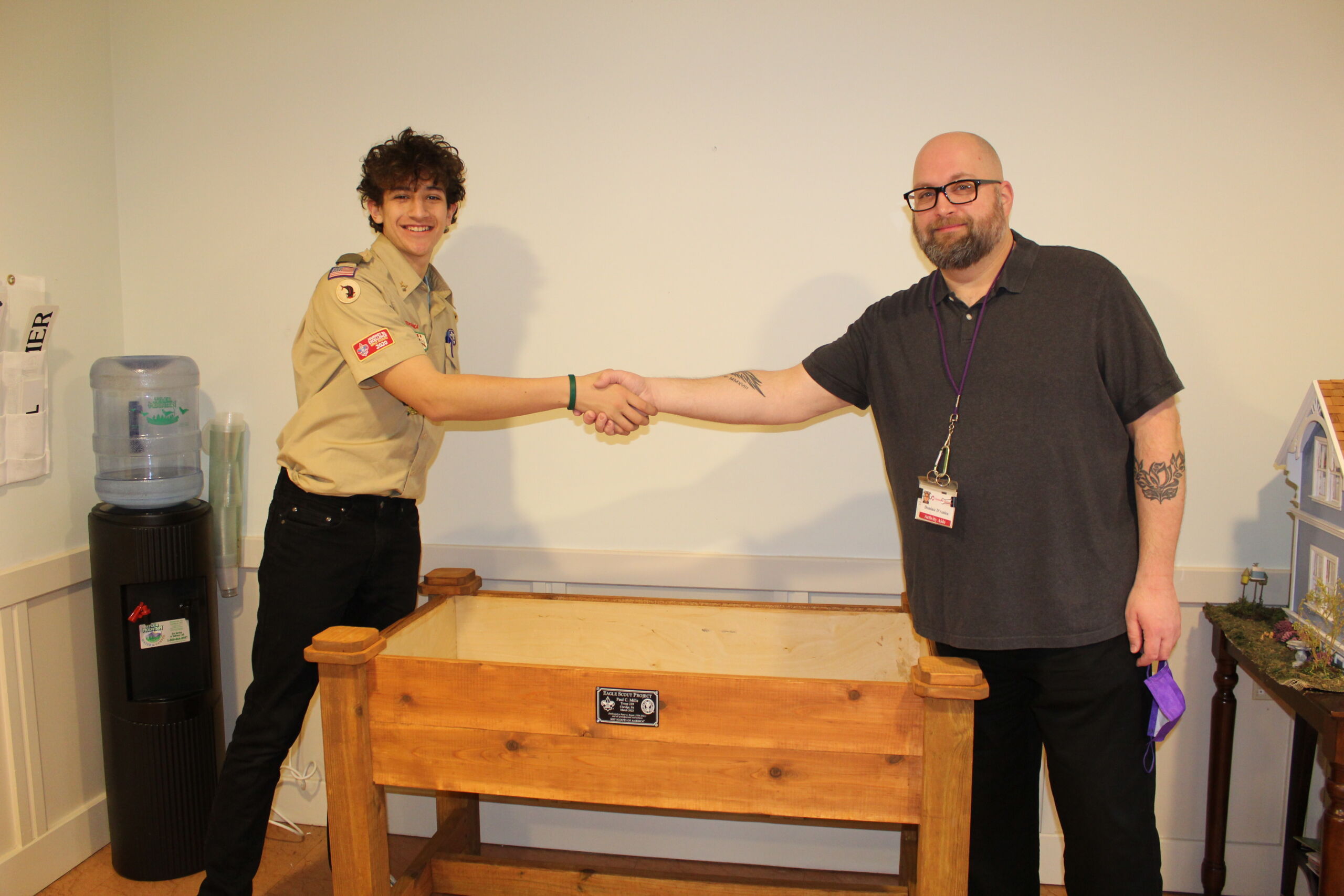 Redstone team member posing with an Eagle Scout and their completed project