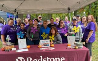 Redstone team members at a fundraising booth