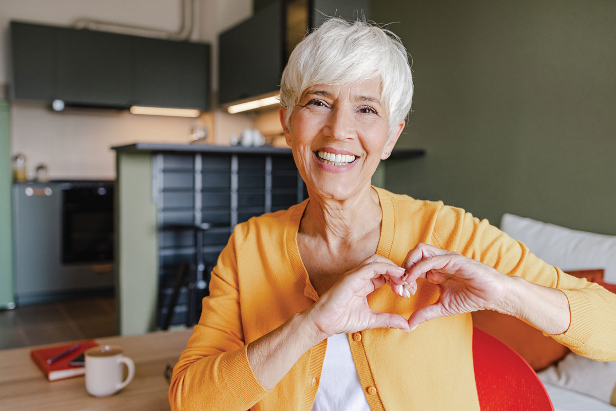 elderly woman heart hands