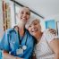 nurse hugging senior citizen