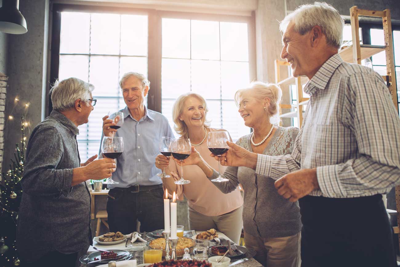 seniors gathered around a wine and cheese gathering